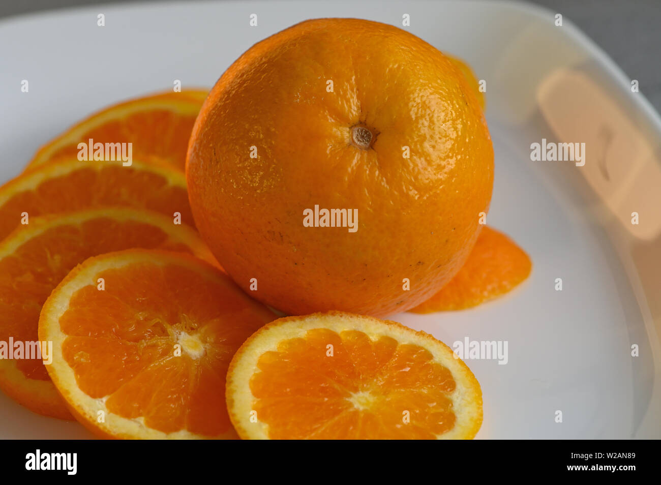 Close up of Orange slices on white plate Stock Photo