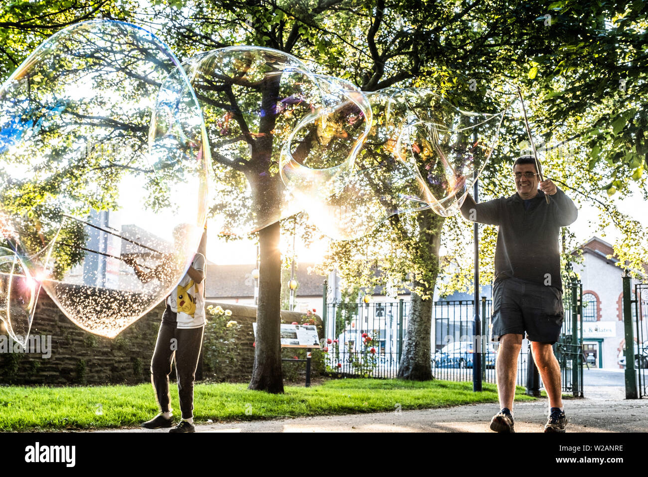 Aberystwyth Wales UK, Sunday 07 July 2019  UK Weather: A family in the park in Aberystwyth have fun making and playing  with giant soap bubble in the evening sunshine at the end of a warm summers day  in west Wales.   photo credit: Keith Morris/Alamy Live News Stock Photo