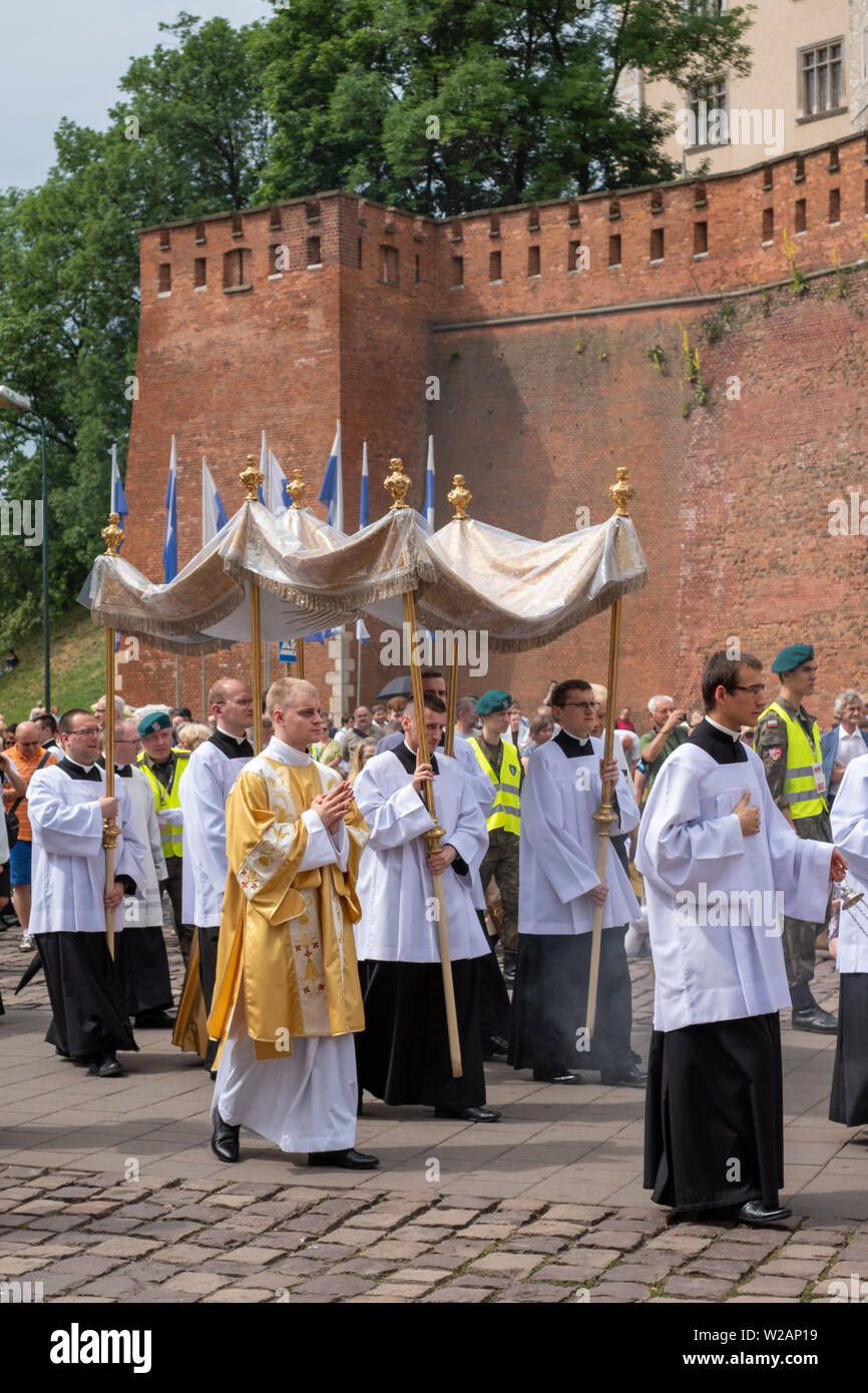 Carrying the canopy at the Corpus Christi procession taking place in the streets of Krakow old town near the Castle, Poland Stock Photo