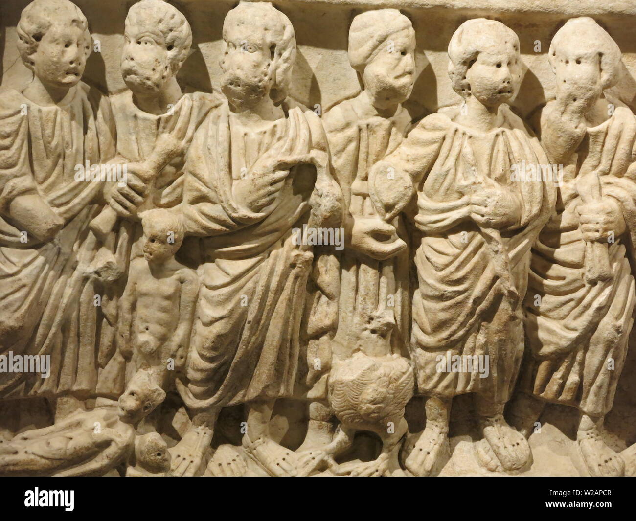Six sculpted figures on the side of a marble sarcophagus; one of the ...