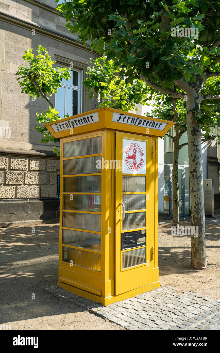 Frankfurt, Germany. July 2019.   An ancient yellow Phone Booth in the city Stock Photo