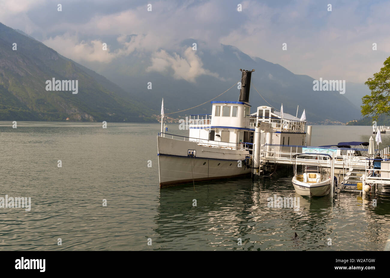 LAKE COMO, ITALY - JUNE 2019: Old steam passenger boat Bisbino berthed permanently in Cadenabbia on Lake Como. It is now a restaurant and bar Stock Photo