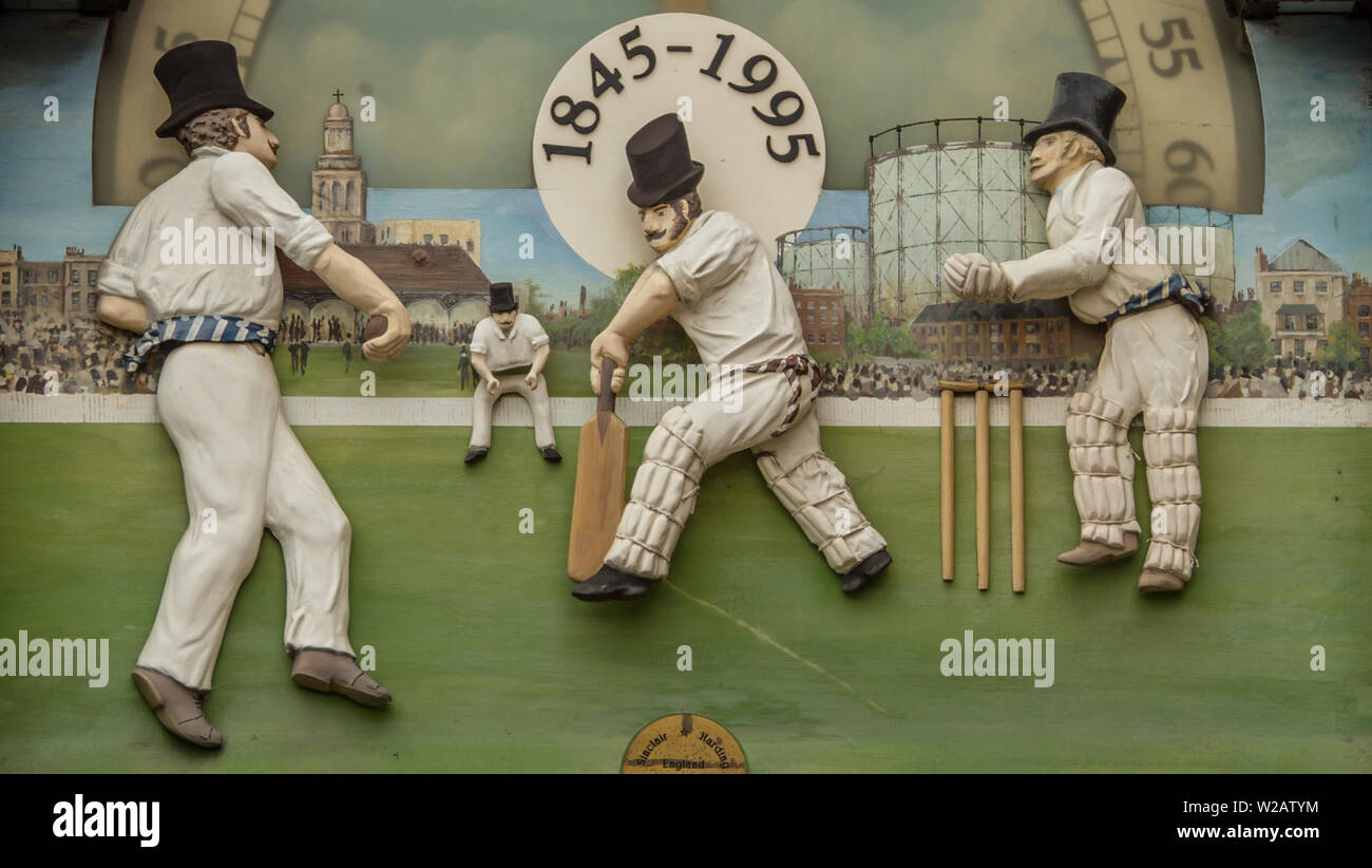 London, UK. 7 July, 2019. Cricket figure details on the old clock at the members entrance ahead of the first day of the Specsavers County Championship game between Surrey and Kent at the Kia Oval. David Rowe/Alamy Live News Stock Photo