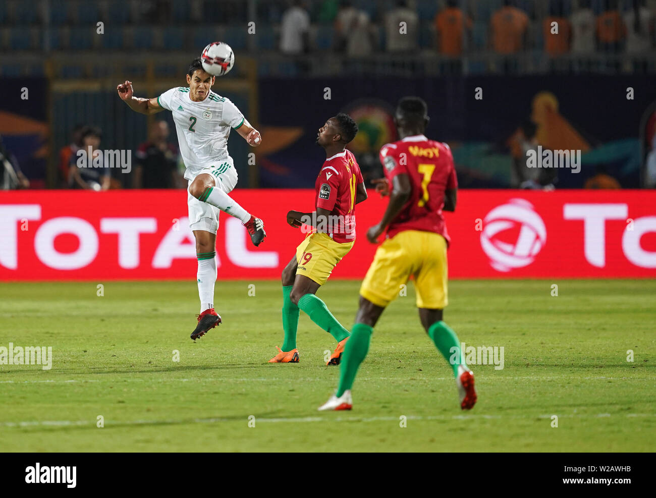 Cairo, Egypt. 07th July, 2019. FRANCE OUT July 7, 2019: Aissa Mandi of Algeria heading the ball in front of FodeÌ Bangaly Koita of Guinea during the 2019 African Cup of Nations match between Algeria and Guniea at the 30 June Stadium in Cairo, Egypt. Ulrik Pedersen/CSM. Credit: Cal Sport Media/Alamy Live News Stock Photo