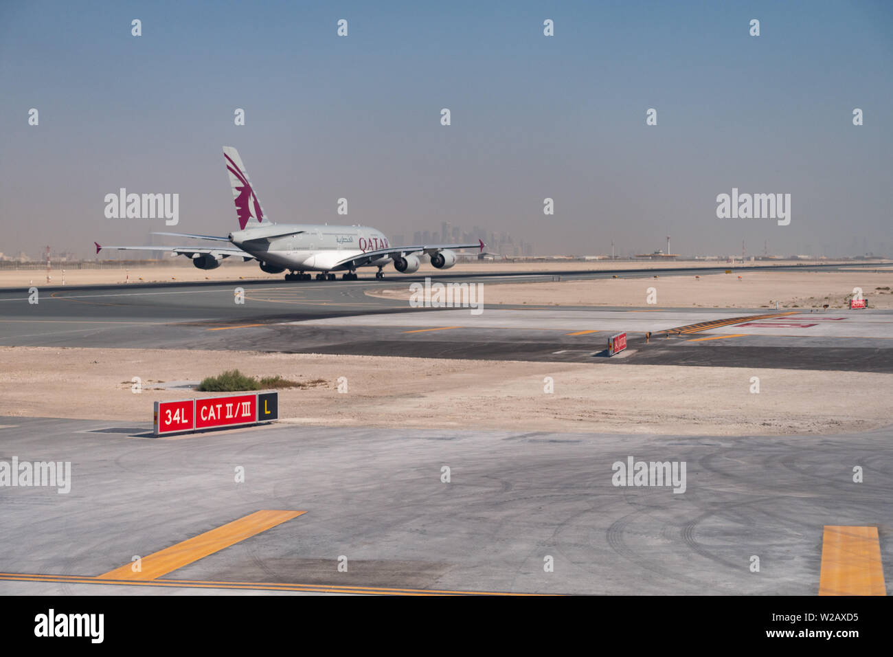 A Qatar Airways Airbus A380-800 superjumbo jet accelerates for takeoff at Hamad International Airport, Doha, State of Qatar Stock Photo
