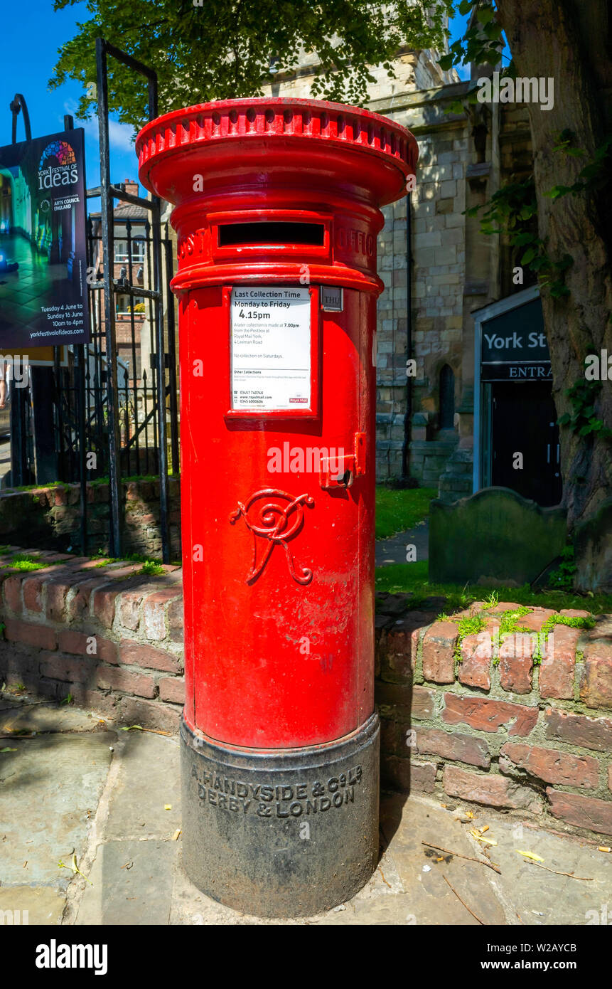 An old post box from Victorian times with insignia VR for Victoria Regina in York City Centre Stock Photo