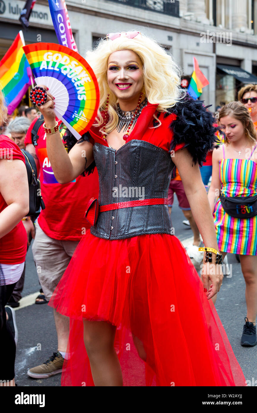 6 July 2019 - A drag queen wearing corset, red dress and fan, London Pride Parade, UK Stock Photo