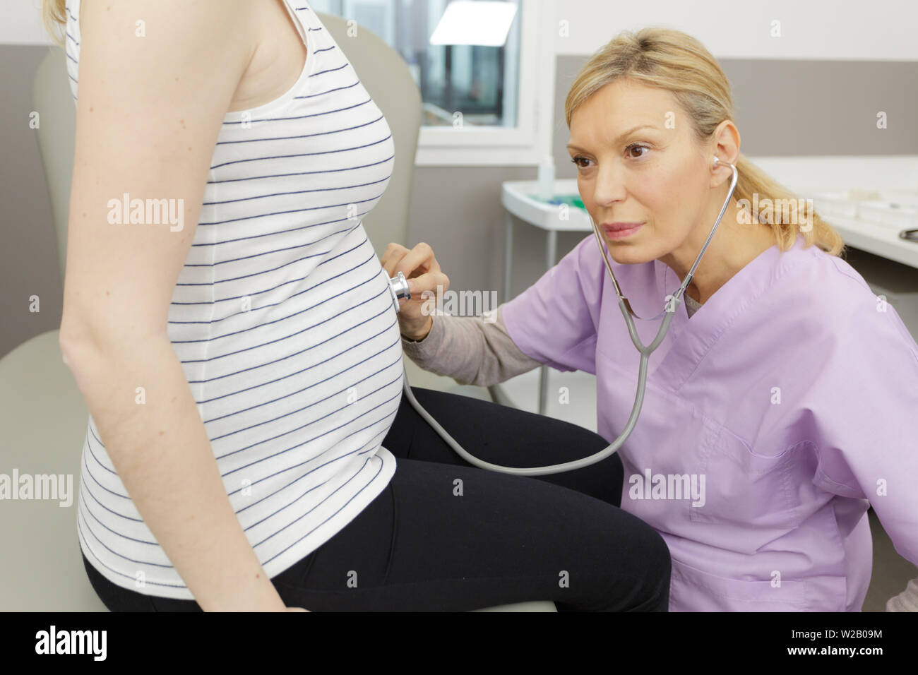 gynecologist listening to bump with stethoscope Stock Photo - Alamy