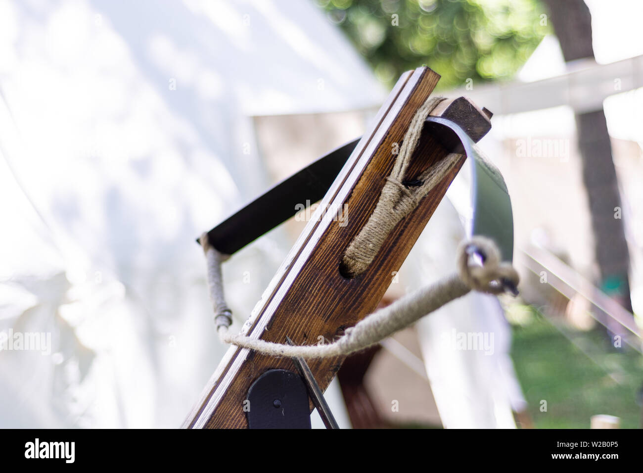 Old big medieval crossbow without an arrow in open outdoor museum and blurred background. Medieval war equipment concept. Close up, selective focus Stock Photo