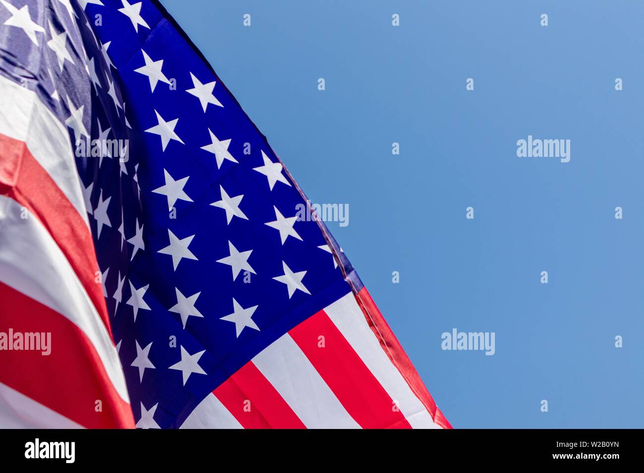 american flag on blue sky background Stock Photo - Alamy