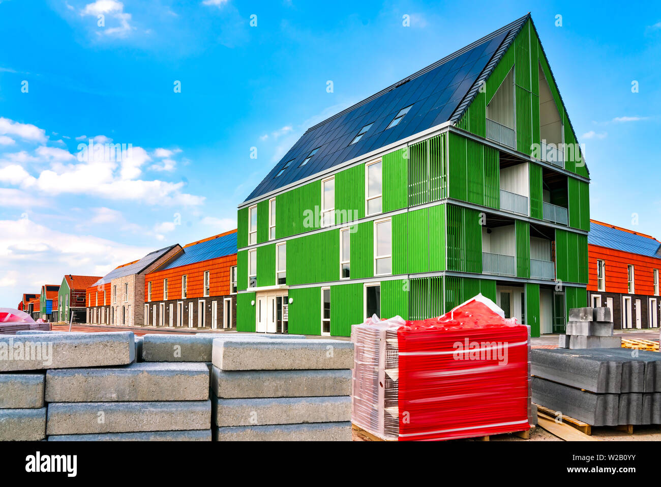 View on construction site. New construction with roof solar panels Stock Photo