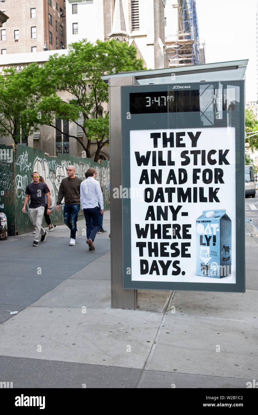 A funny clever advertisement for Oatly oat milk displayed on the side of a bus waiting station in Midtown Manhattan, New York City. Stock Photo