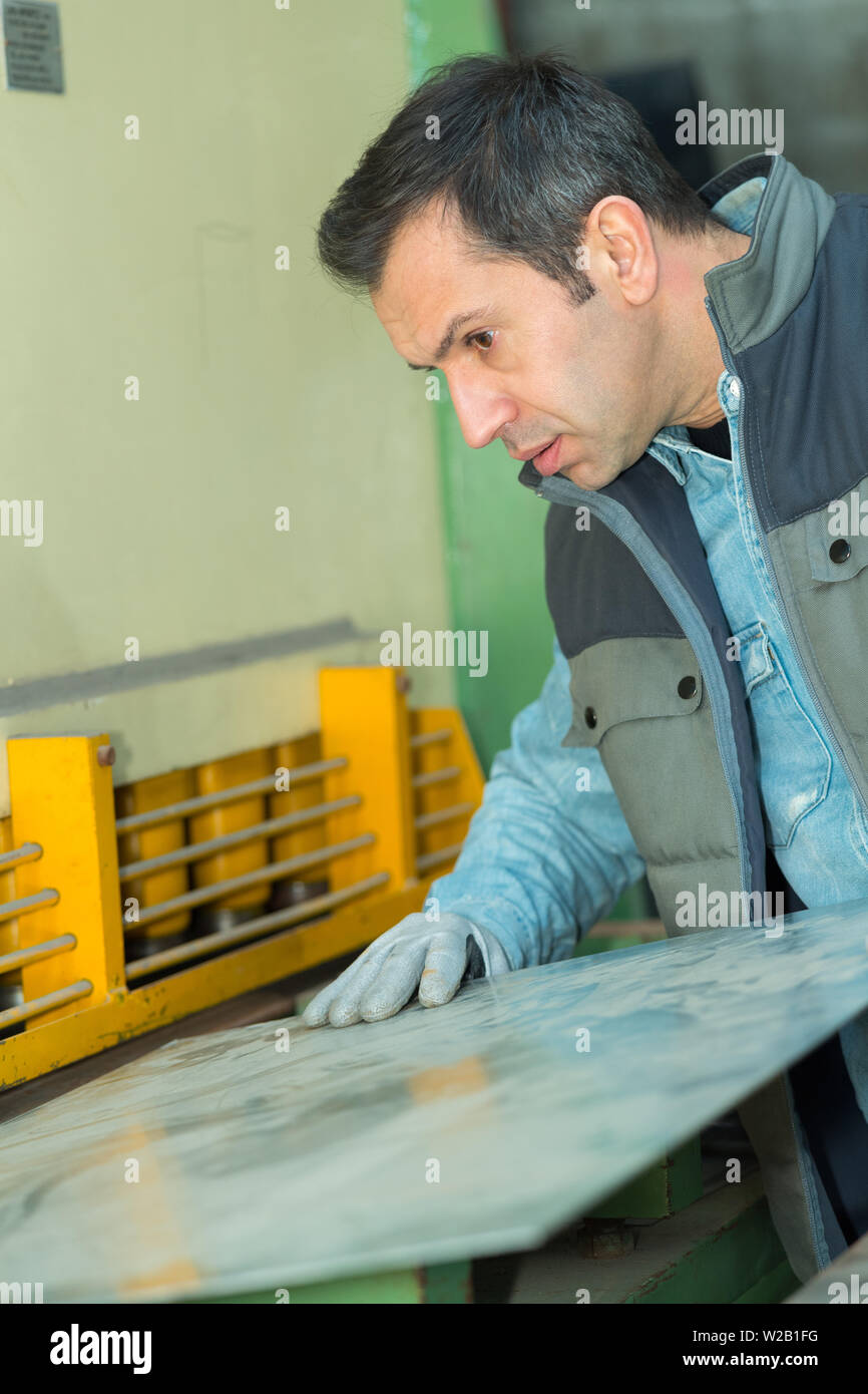 Metal Inserting Machine inserting metal plate into machine Stock Photo - Alamy