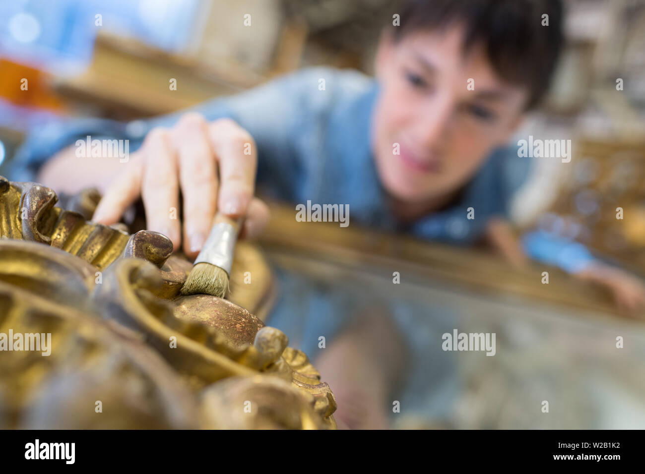 portrait of woman restoring an antique mirror Stock Photo Alamy
