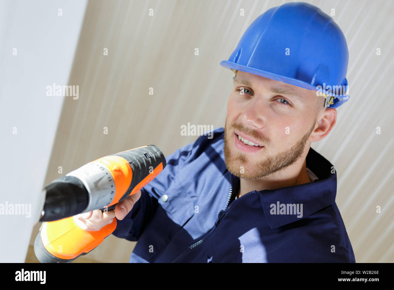 high-angle view of builder using cordless drill Stock Photo