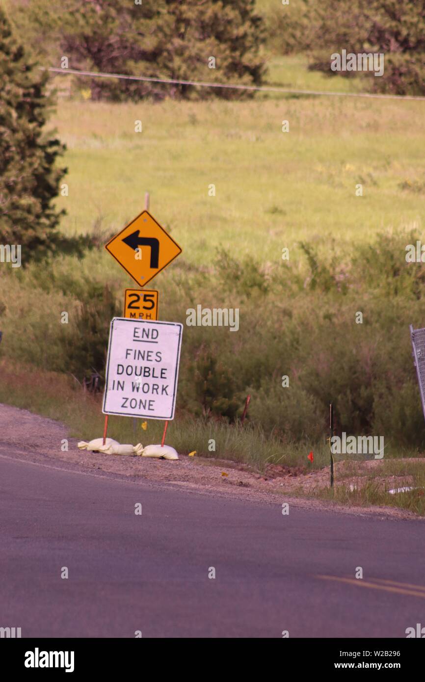 Caution! Left turn, 25 MPH, end fines double in work zone Stock Photo