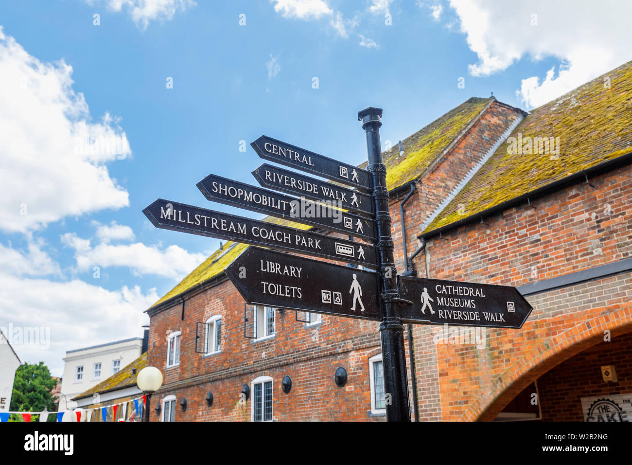 Traditional old-fashioned signpost direction sign pointing to attractions and amenities in Salisbury town centre, a cathedral city in Wiltshire, UK Stock Photo