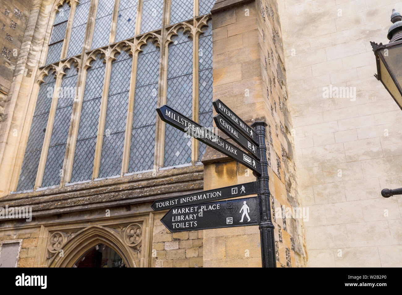 Traditional old-fashioned signpost direction sign pointing to attractions and amenities in Salisbury town centre, a cathedral city in Wiltshire, UK Stock Photo
