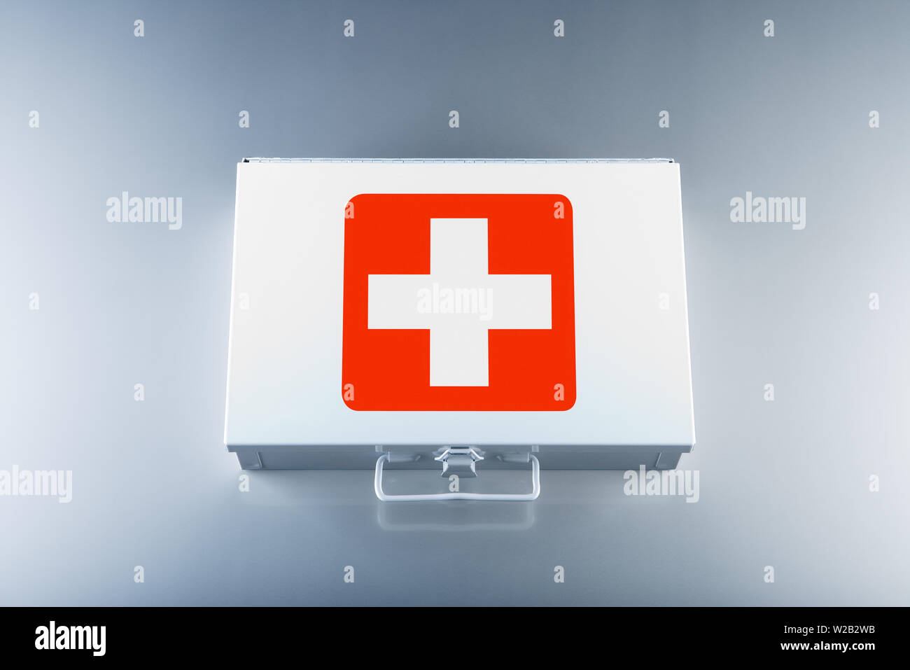 Tin first aid kit with cross emblems on grey background Stock Photo