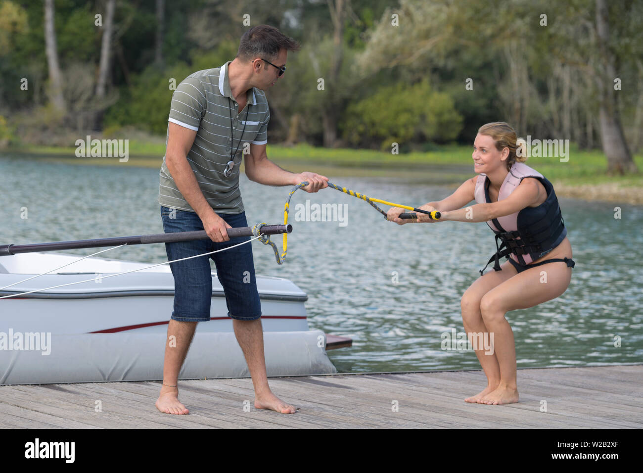 instructor showing woman how to waterski Stock Photo Alamy