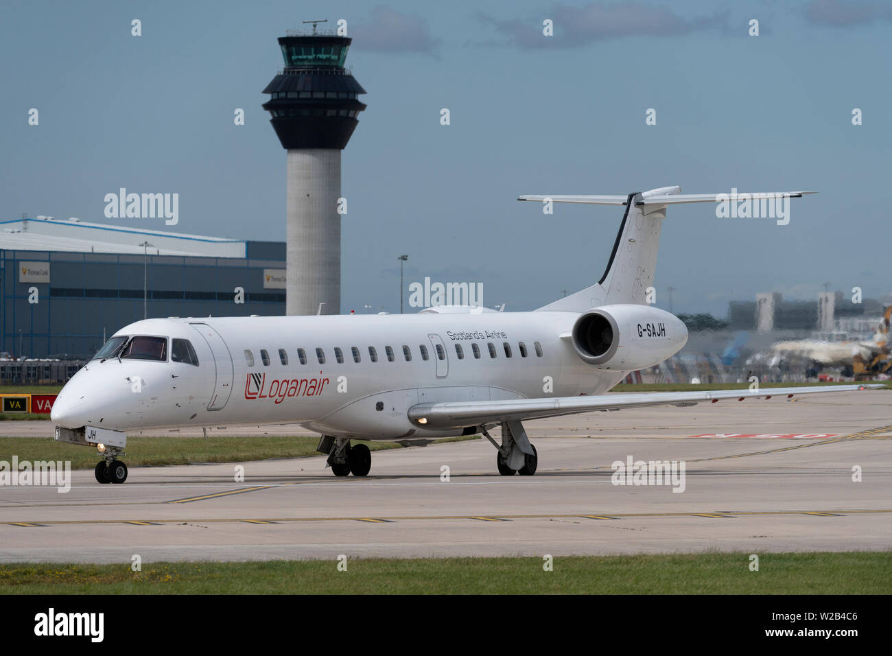 A Loganair Embraer ERJ-145EU taxis on the runway at Manchester Airport, UK. Stock Photo