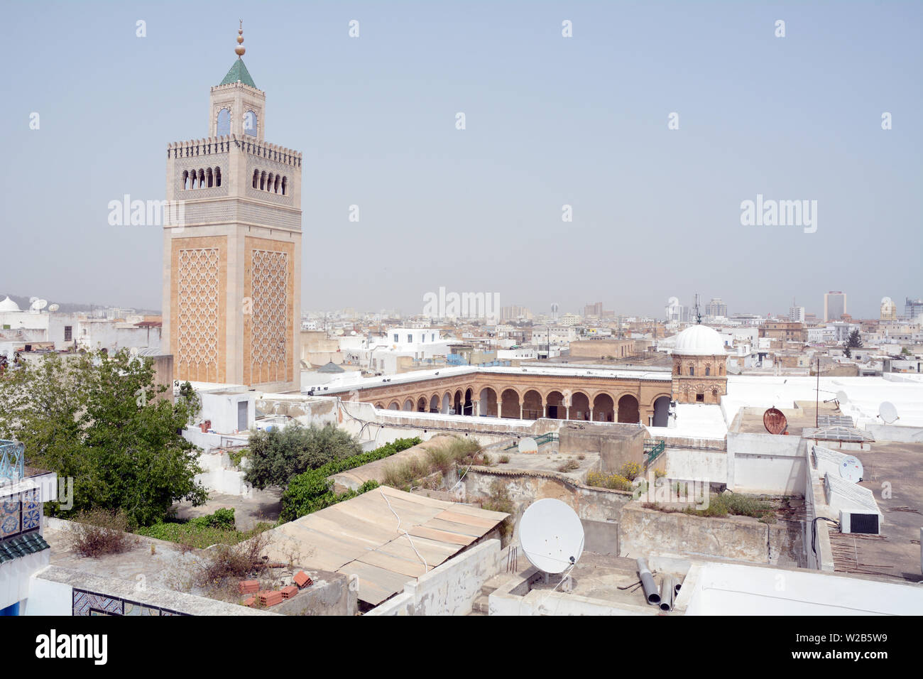 A rooftop view of the Tunis old city and medina overlooking the Zeitoun mosque and its square minaret, Tunisia. Stock Photo
