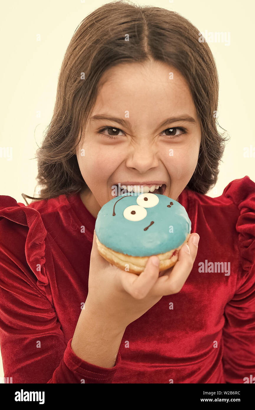 Kid girl hungry for sweet donut. Donut so popular. Sugar levels