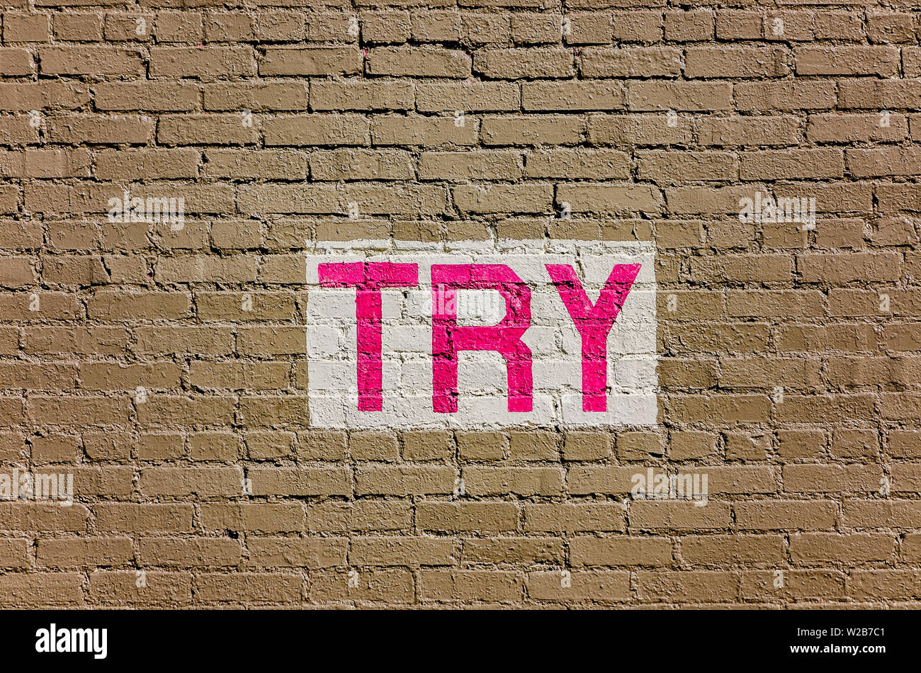 The word “try” is painted on a brick wall, Sept. 12, 2015, in Memphis, Tennessee. Stock Photo