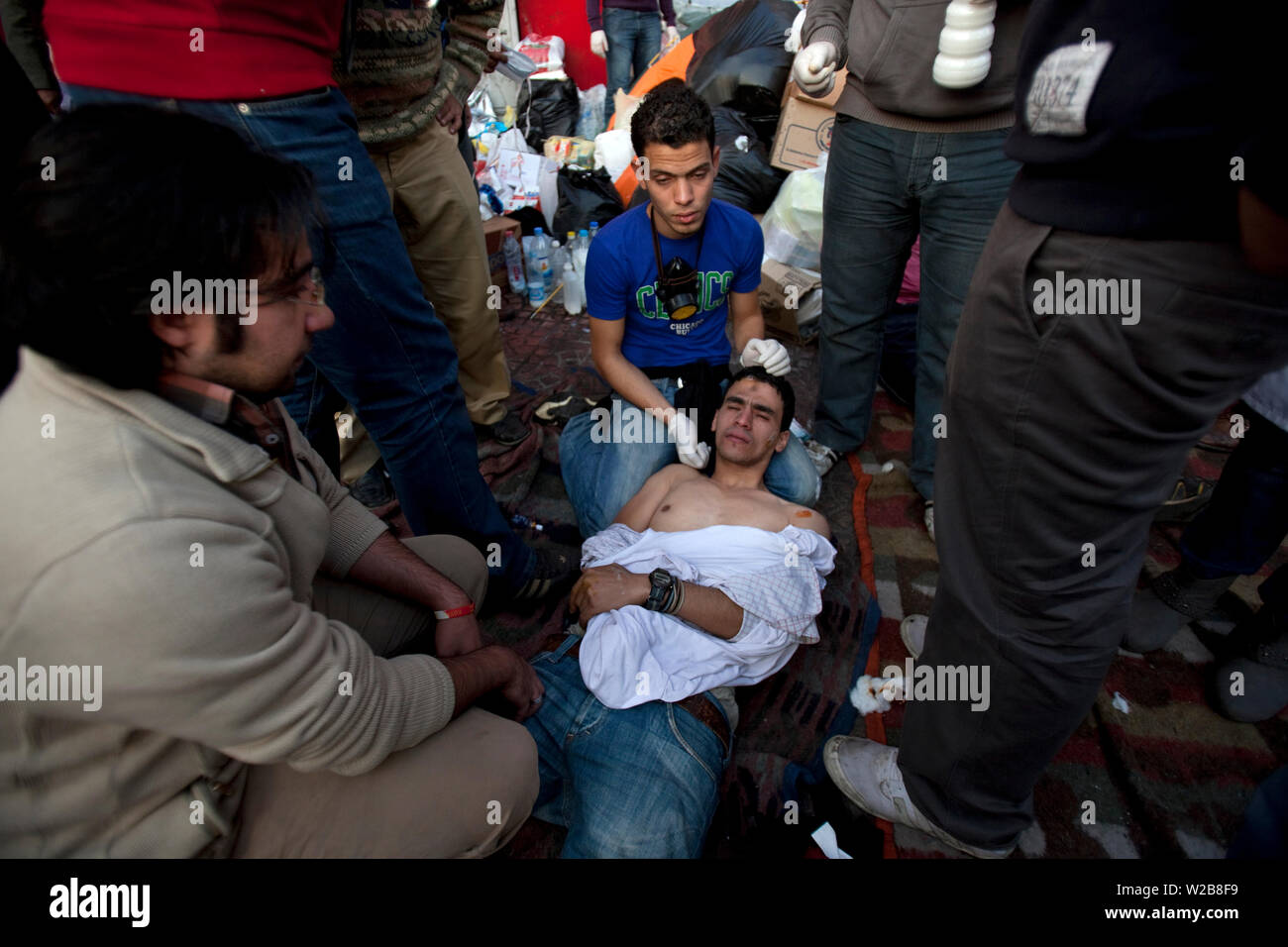 November 21, 2011 – Cairo, Egypt - Egyptian medical team treat an Egyptian protester injured by rubber bullets at a field clinic in Cairo’s Tahrir Square. Security forces fired tear gas and rubber bullets during clashes with several thousand protesters in Cairo's Tahrir Square in the third straight day of violence that has killed at least 24 people and has turned into the most sustained challenge yet to the rule of Egypt's military. Protesters are calling on the ruling military to quickly announce a date for the transfer of power to a civilian administration. The clashes were the biggest outbr Stock Photo
