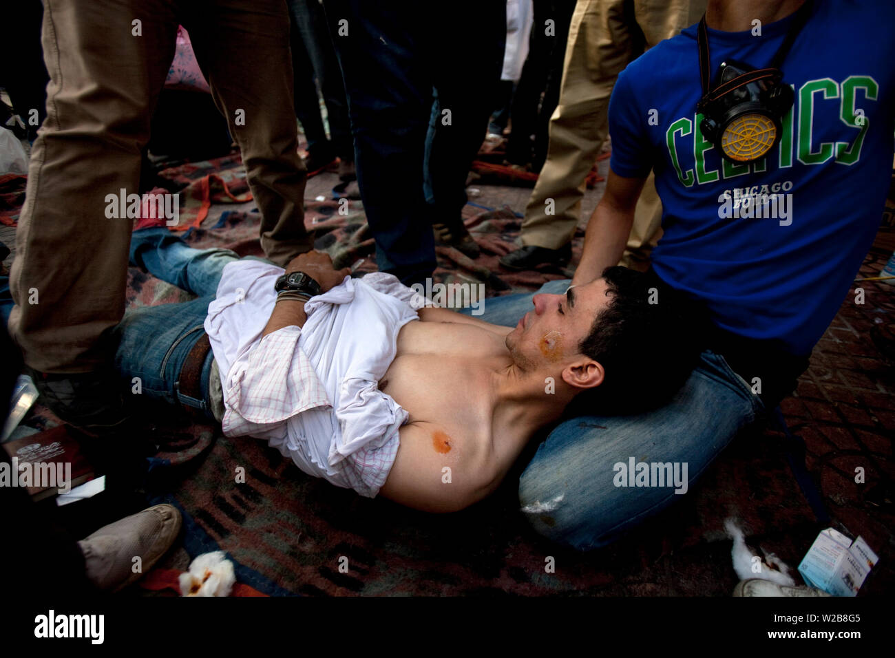 November 21, 2011 – Cairo, Egypt – Egyptian medical team treat an Egyptian protester injured by rubber bullets and tear gas at a field clinic in Cairo’s Tahrir Square. Security forces fired tear gas and rubber bullets during clashes with several thousand protesters in Cairo's Tahrir Square in the third straight day of violence that has killed at least 24 people and has turned into the most sustained challenge yet to the rule of Egypt's military. Protesters are calling on the ruling military to quickly announce a date for the transfer of power to a civilian administration. The clashes were the Stock Photo