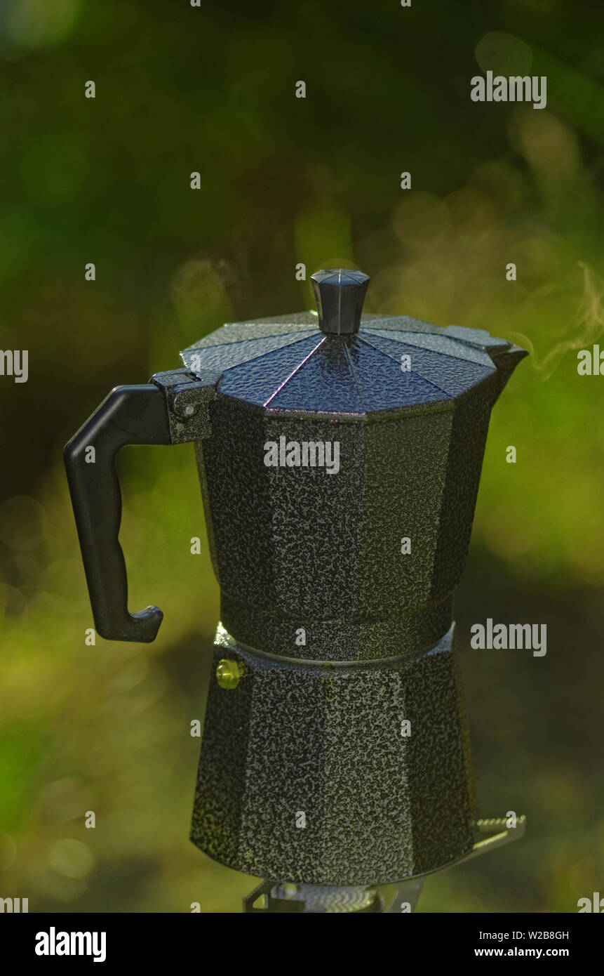 An espresso coffee pot on a single burner camp stove Stock Photo Alamy
