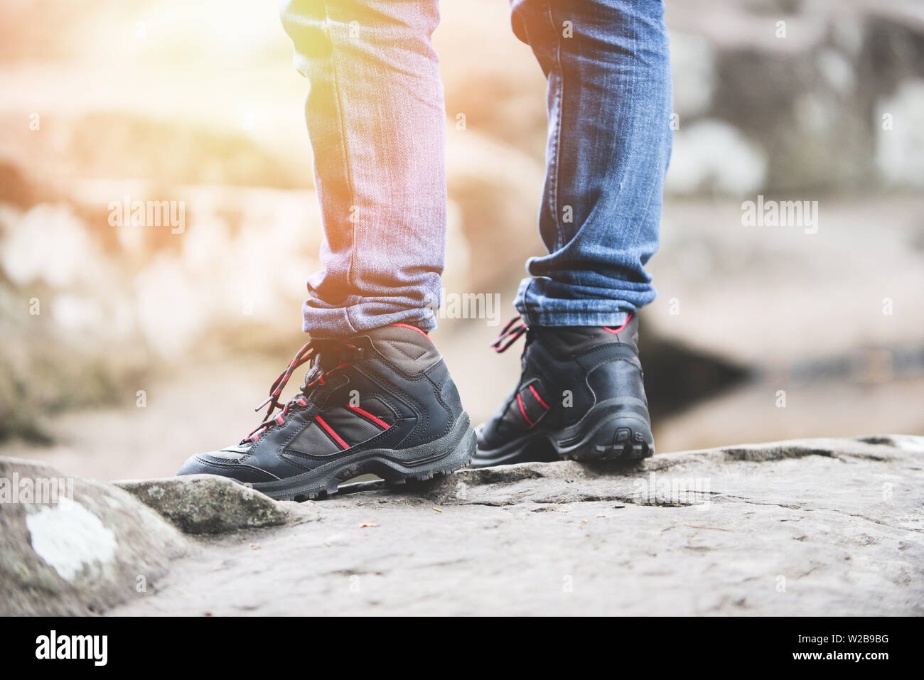 traveler walking in forest in the rock mountains / Man hiker legs and