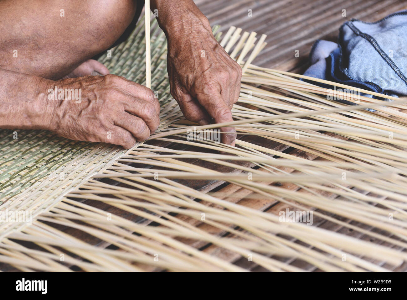 weaving bamboo basket wooden / old senior man hand working crafts hand made basket for nature product in Asian Stock Photo