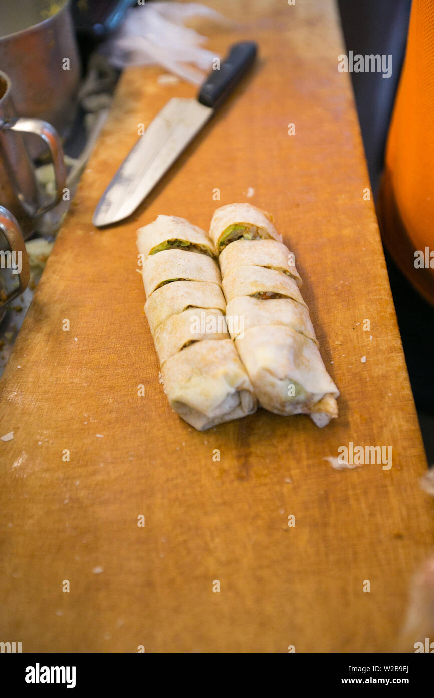 Popiah or fresh spring roll rolled up and slice beautiful on a chopping ...