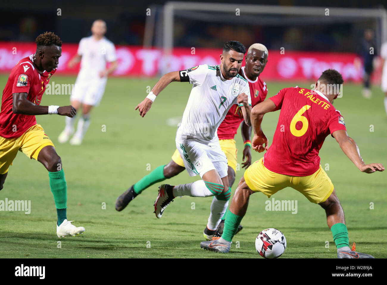 Cairo, Egypt. 7th July, 2019. Riyad Mahrez (C) of Algeria vies with Simon Falette (1st R) of Guinea during the 2019 Africa Cup of Nations match between Algeria and Guinea in Cairo, Egypt, on July 7, 2019. Algeria won 3-0. Credit: Ahmed Gomaa/Xinhua/Alamy Live News Stock Photo