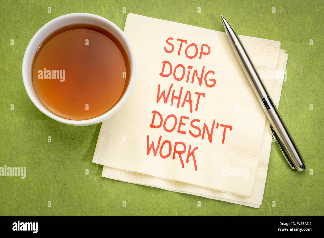 stop doing what does not work - motivational handwriting on a napkin with a cup of tea Stock Photo