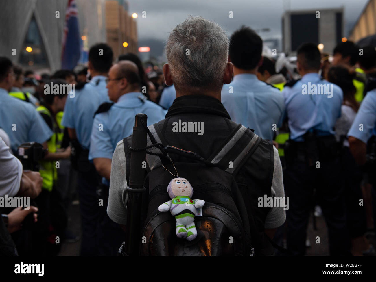 Hong Kong, China. 07th July, 2019. A police officer carries a Toy Story Buzz Light-year stuffed toy on his backpack during the protest.Thousands of anti-government protesters marched and rallied to the West Kowloon High Speed Railway Station to demand the Hong Kong government to withdraw the extradition bill and to set up an independent commission to investigate on the police brutality while they used force to handle the protesters during the anti-extradition bill protests in June. Credit: SOPA Images Limited/Alamy Live News Stock Photo