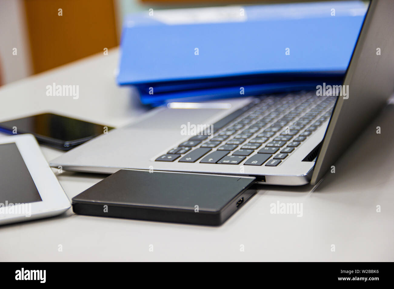laptop computer on desk table in work office and  external Harddisk ,files folder , concept business life work office Stock Photo