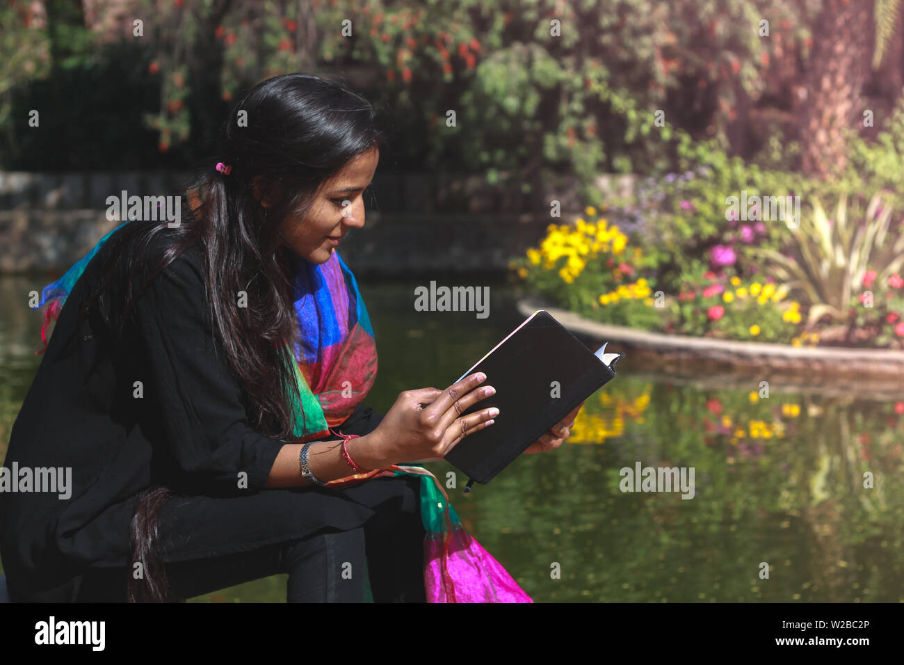 Young Beautiful Indian Women Enjoying Solitude And Reading A Book