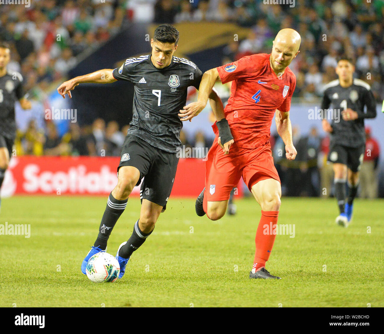 Chicago, IL, USA. 07th July, 2019. Mexico forward, Raul Jimenez (9), and US midfielder, Michael Bradley (4), work for ball control during the 2019 CONCACAF Gold Cup, championship match, between the United States and Mexico, at Soldier Field in Chicago, IL. Credit: Kevin Langley/CSM/Alamy Live News Stock Photo