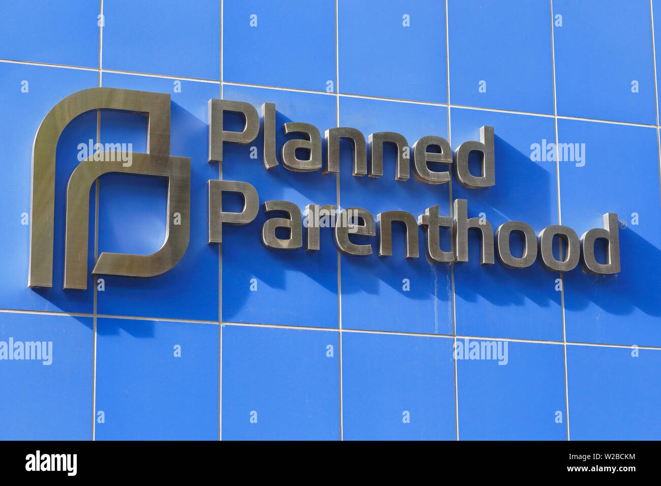 Planned Parenthood raised logo on a blue tile wall Stock Photo