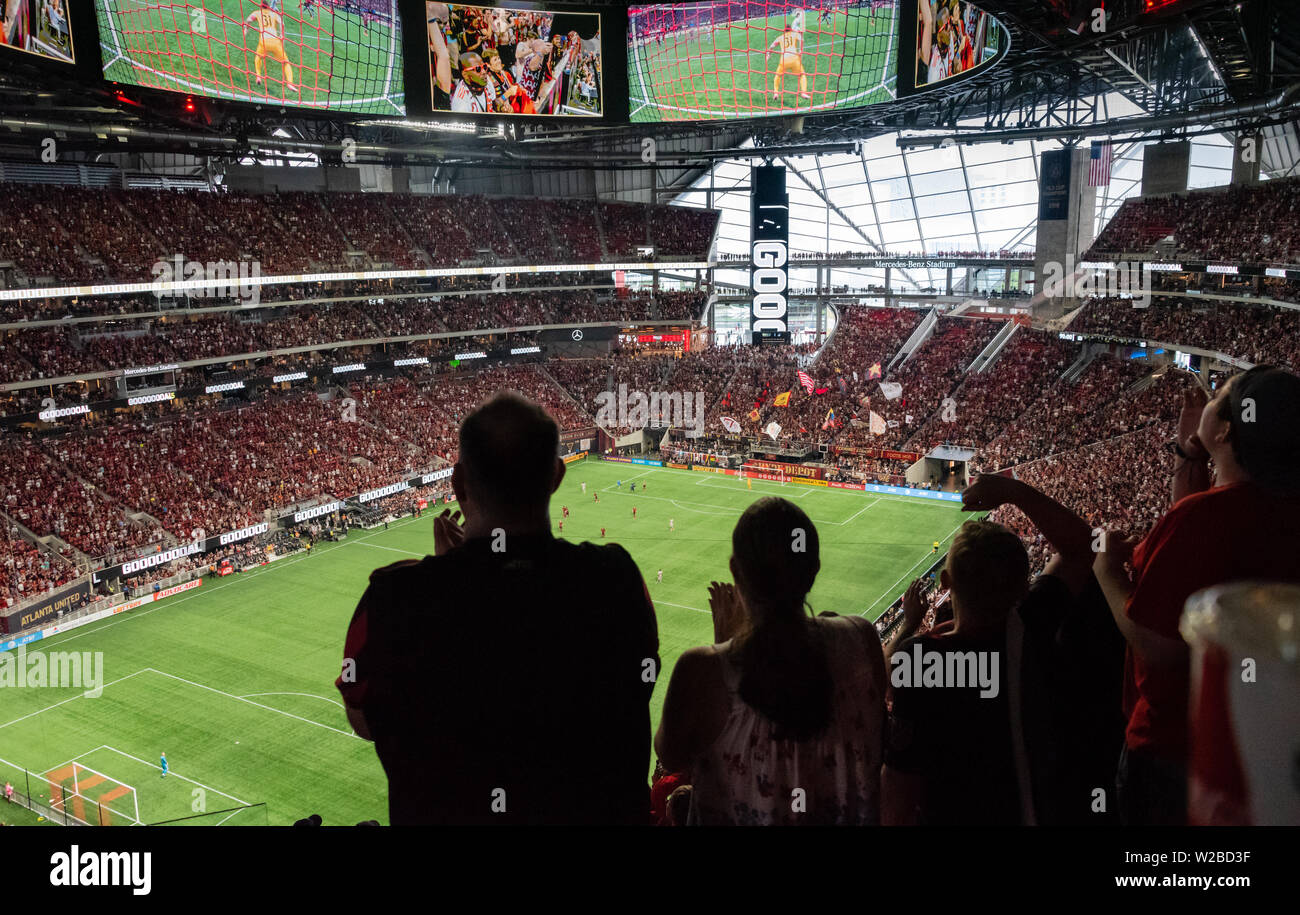 Atlanta United soccer fans celebrating after a goal is scored by their team against the New York Red Bulls at Mecedes-Benz Stadium in Atlanta. (USA) Stock Photo