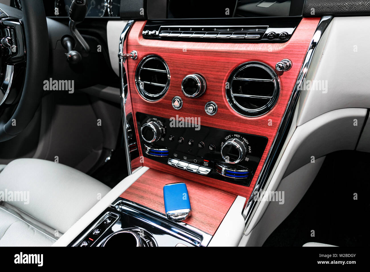 Modern luxury car white leather interior with natural wood panel. Part of leather car seat