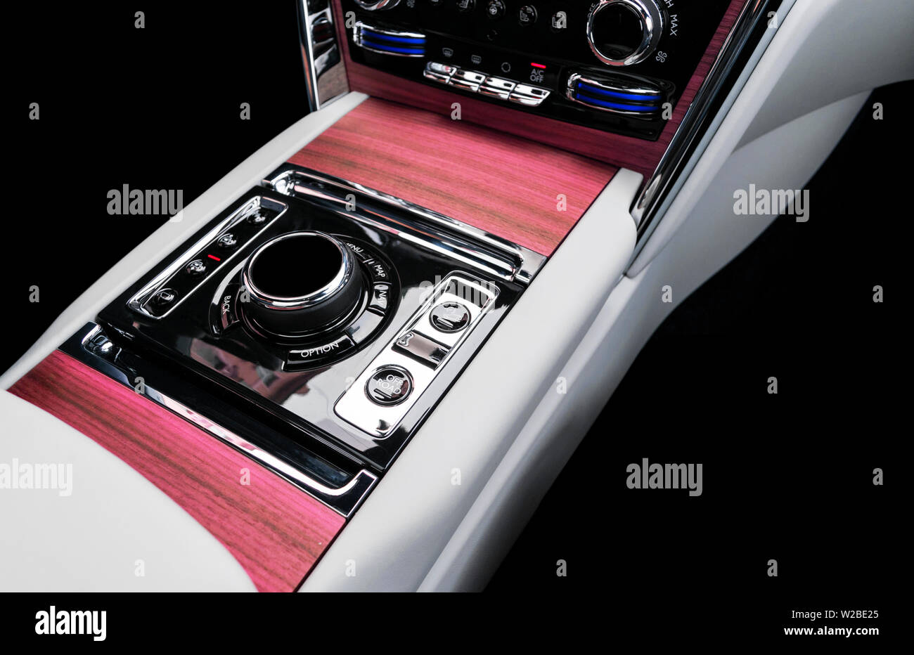 Modern luxury car white leather interior with natural wood panel. Part of leather car seat