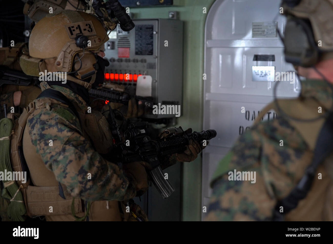Force Reconnaissance Marines with Maritime Raid Force, 31st Marine Expeditionary Unit, prepare to breach a door while clearing the bridge during a visit, board, search and seizure exercise aboard the amphibious dock landing ship USS Ashland (LSD 48), underway in the Coral Sea, June 29, 2019. Ashland, part of the Wasp Amphibious Ready Group, with embarked 31st MEU, is operating in the Indo-Pacific region to enhance interoperability with partners and serve as a ready-response force for any type of contingency, while simultaneously providing a flexible and lethal crisis response force ready to pe Stock Photo