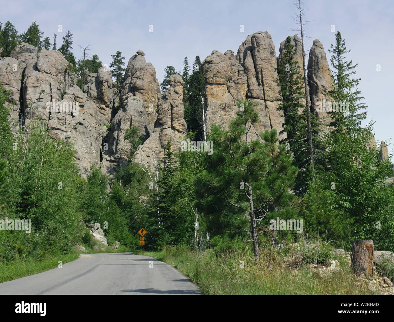 Scenic drive in South Dakota with a view of granite mountains and rock