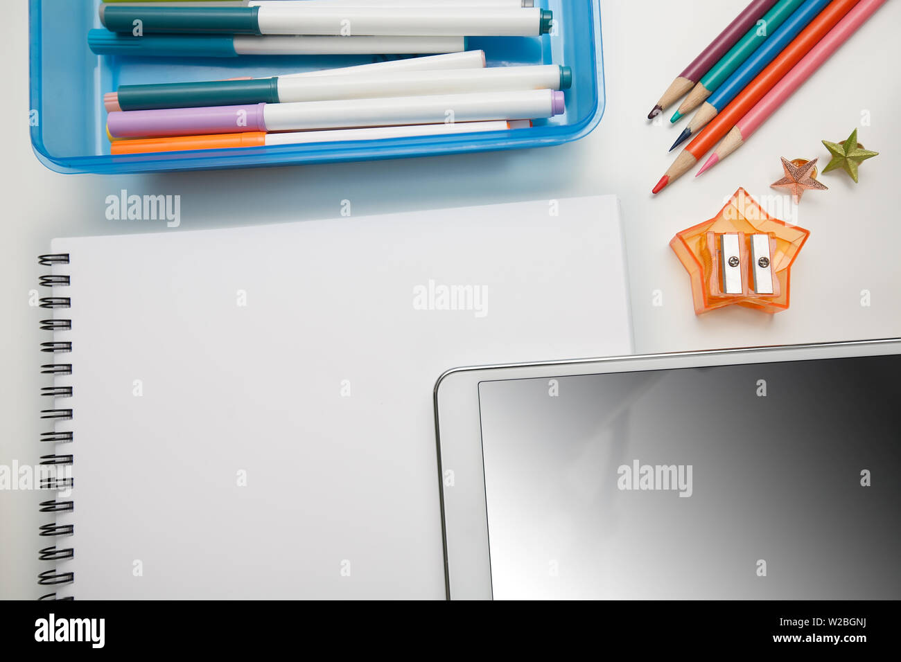Student supplies for elementary school with a blank notepad and tablet touchscreen. Stock Photo