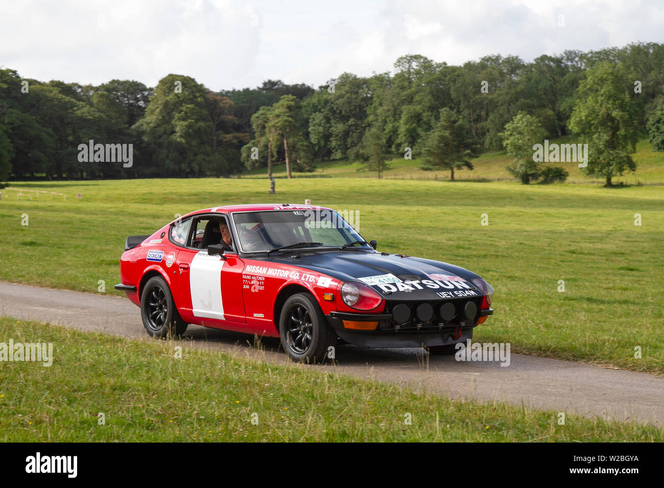 1972 70s seventies Nissan Datsun 240Z supercar at Classic Car Rally July 2019. Mark Woodward’s midsummer classic car show traveled to scenic Carnforth to showcase more classics, historics, vintage motors and collectables at this year’s Leighton Hall transport show, an opportunity to see over 500 classic vehicles of yesteryear at one of the most comprehensive and diverse shows in the summer classic car event. Stock Photo