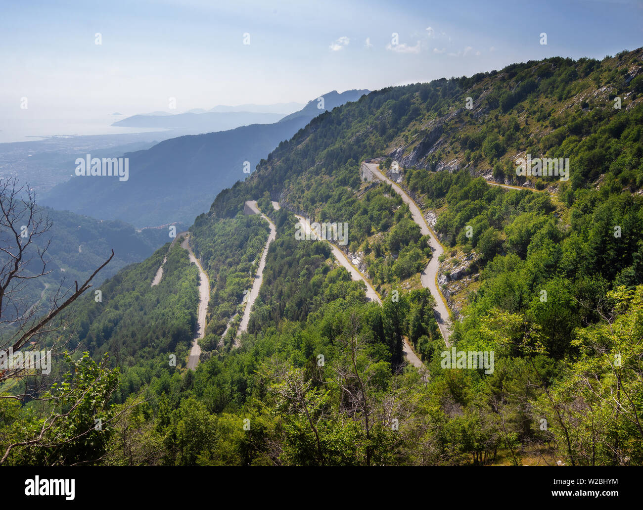 View of zigzag mountain road with hairpin bends in the Apuan Alps, Alpi Apuane, near the Vestito Pass. Above Massa Carrara, Italy. Less travelled. Stock Photo