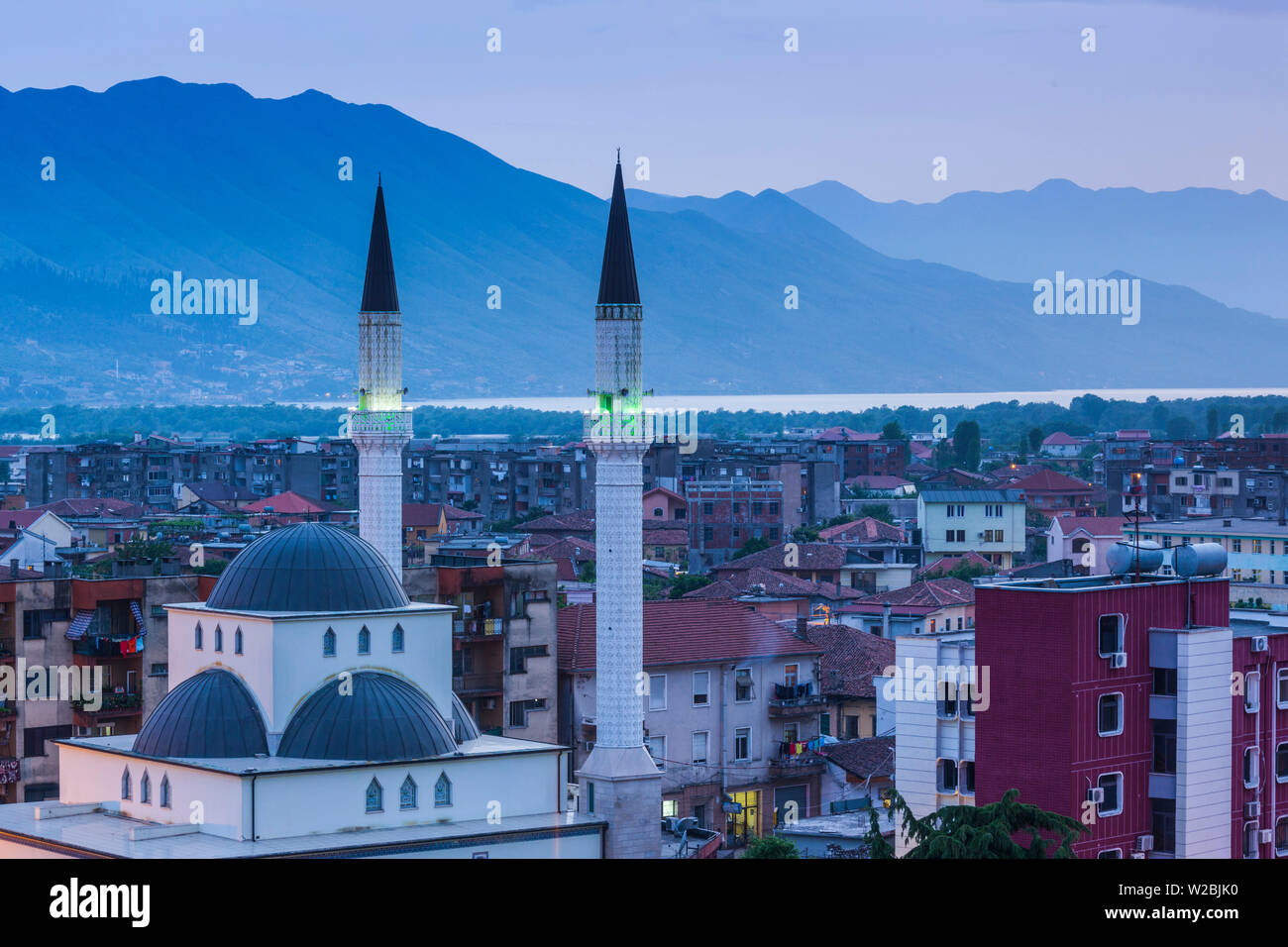 Albania, Shkodra, elevated view of Zogu 1 Boulevard and mosque, dusk Stock Photo